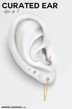 an ear with gold chains and pearls on it is featured in the ad for jewelry