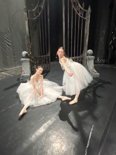 two young ballerinas in white tutu skirts are posing for the camera on stage