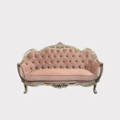 an antique style couch with pink velvet upholstered