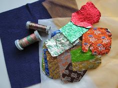 a piece of fabric and some thread sitting on top of a table