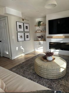 a living room with a large television mounted on the wall