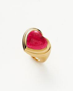 Share the love. The chubby jelly heart gemstone ring is set with a dyed pink quartz cabochon stone – known for bringing love – surrounded by signature ridge detailing on a domed band. Wear solo or stack with other chunky pieces. This piece contains a semi-precious gemstone that is natural, meaning each stone is complet Valentine's Day Pink Ruby Ring, Pink Heart Cut Ruby Ring For Valentine's Day, Luxury Yellow Gold Heart Ring With Gemstone, Pink Heart-shaped Gemstone Ring, Fine Jewelry Pink Rings With Polished Finish, Pink Heart-shaped Rings For Formal Occasions, Pink Rings With Polished Finish Fine Jewelry, Luxury Heart Ring With Gemstone, Luxury Pink Jewelry With Heart Charm