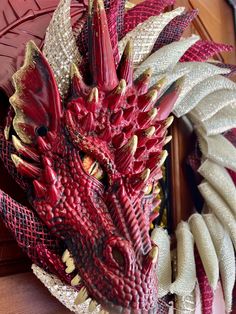 a red dragon head hanging on the side of a wall