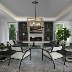 a living room filled with furniture and a flat screen tv mounted on a wall above a fireplace