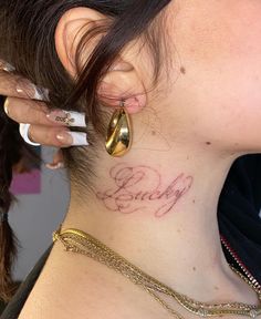 a close up of a person with a tattoo on their neck and behind her ear