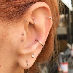 a woman with three different piercings on her ear