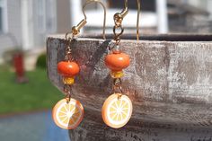 Price is for 1 pair of food earrings.   Please select which dangle earring set you want. Now available in:     - Dragonfruit     - Oranges A touch of sweet, a touch of charm! These cute food earrings add summer color and summer fun to any outfit. These dangle earrings boast bright colors and a fresh feel for spring, summer and more! Clay polymer charms, gold colored nickel free ear wires and glass beads. Clay polymer earrings. Please select which set of earrings you want.  Great gift under 10! I loved the playful fruit charms in bright colors! Wonderful for adding color to your outfits, or a great gift for any foodie! A gift for her, gift for teen, gift for girl, gift for sister, gift for mom, gift for friend, thank you gift, gift for teacher, gift for summer, tropical earrings, food earri Fun Orange Dangle Earrings, Fun Orange Drop Earrings, Fun Orange Dangle Jewelry, Fun Orange Earrings As A Gift, Fun Orange Earrings For Gift, Fun Orange Earrings For Gifts, Fun Orange Earrings For A Gift, Cute Nickel-free Orange Jewelry, Cute Orange Handmade Jewelry