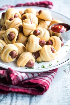 a white plate topped with pigs in a blanket