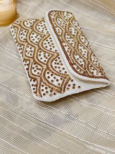 Thank you so much for visiting my shop ! Beautiful and Elegant Crystal handcrafted clutch can be a perfect fit for any occasion or event, Specially for bride. Traditional White Evening Bag For Parties, White Embellished Clutch For Party, Gold Clutch With Zari Work For Wedding, White Rectangular Evening Bag For Festive Occasions, Festive White Clutch For Party, Celebration Clutch With Handwork, Gold Evening Bag With Zari Work For Celebrations, White Evening Bag With Handwork For Wedding, Bollywood Style Clutch With Zari Work For Celebration