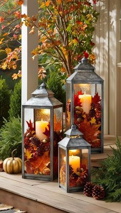 three lit candles sitting on top of a porch