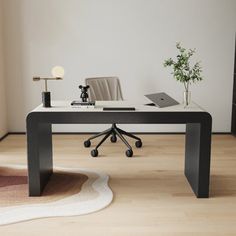 a desk with a laptop on it and a rug in the corner next to it