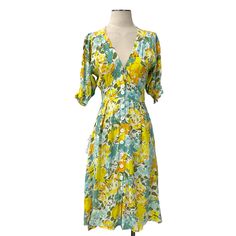 Faithfull The Brand- Rafa Midi Dress In Annina Floral Print Size Xs (2). White Background With Bright Yellow, Orange, Green, Light Blue, And A Dusty Blue Florals. Fabric Texture Is Like A Crepe Feel. No Holes, Stains, Tears. The Hook & Eye Closure At The Front Chest Is A Little Loose (Pic #9). Shoulder-Bottom Measures About 40.5” Long. Armpit-Armpit Measures About 17.5” Across Laid Flat. Waist Measures About 13.5” Across Laid Flat. Original Tag Attached. (S5-37) Blue Florals, Faithfull The Brand, Fabric Texture, Hook Eye, Green Light, Bright Yellow, Dusty Blue, Yellow Orange, Dress Brands