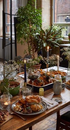 the table is set with food and candles