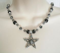 "This beautiful necklace has black pearl beads, black beads with silver engraved stars, seed beads, sterling silver plated filigree beads, pewter silver bead caps and a pewter silver pentagram. 18\" long. Sterling silver plated toggle clasp." Gothic Star-shaped Jewelry For Festivals, Black Gothic Star Necklace, Gothic Black Star Necklace, Gothic Silver Beaded Necklaces With Black Beads, Silver Gothic Jewelry With Round Beads, Gothic Silver Jewelry With Round Beads, Silver Gothic Beaded Necklace For Gift, Silver Gothic Beaded Necklace As Gift, Gothic Silver Beaded Necklace Perfect For Gifts