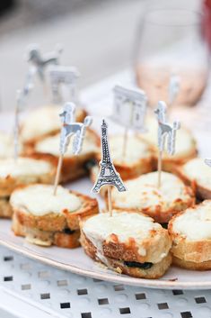 small appetizers with miniature eiffel tower on them sitting on a plate