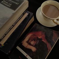 a stack of books next to a cup of coffee