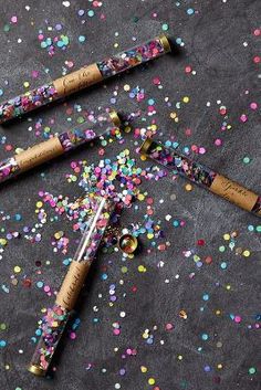 two corks with confetti and sprinkles on them