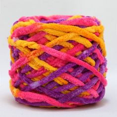 a multicolored ball of yarn sitting on top of a white surface