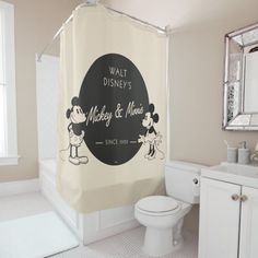 a bathroom with a mickey and minnie shower curtain