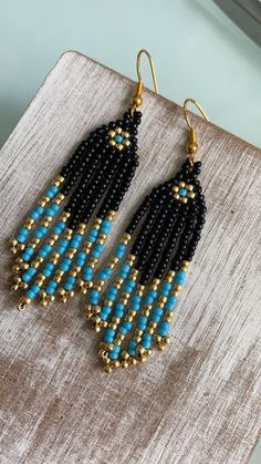 black and blue beaded earrings with gold accents