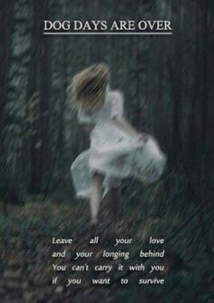 a girl running through the woods in white dress with words on it that read dog days are over