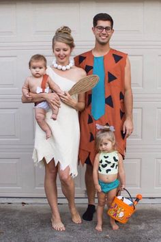 a man, woman and child dressed up in costumes