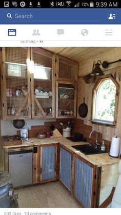 a small kitchen with lots of wood and glass doors on the cabinets, sink and dishwasher