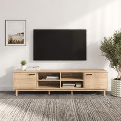 Clean-lined and spacious, this TV stand is the perfect solution for organizing your entertainment space while adding a touch of rustic warmth to your home. Designed to accommodate flat-screen TVs up to 80", it features an engineered wood frame in a warm, natural finish. The stand rests on multiple sturdy cylindrical legs, giving it a bold, modern silhouette that complements contemporary interiors. Tv Console Cheap, Tv Stand 65" Tv, Short Tv Stand, Transitional Tv Stand, Sliding Door Tv Stand, Storage Tv Stand, Landing Space, Coastal Oak, Oak Tv Stand