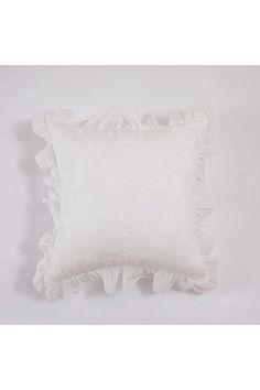 a white pillow with ruffled edges