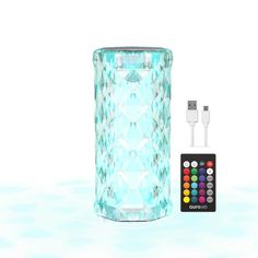 an image of a remote control next to a glass vase with diamond pattern on it