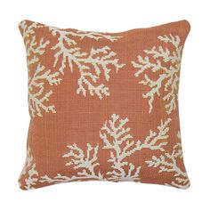 an orange pillow with white snowflakes on it