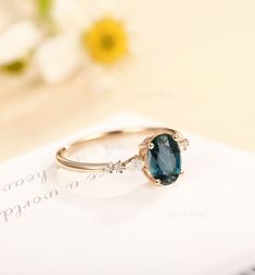 a close up view of a ring with a blue stone on the front and side