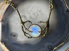 "This Labradorite Necklace feature realistic metal replicas of talons from a Raven or Crow, clutching a stunning cabochon of flashy Rainbow Moonstone.  The chain itself is about 18\" long, and the talons add another 2\" of length to it, bringing it to approximately 20\", but I can shorten (or lengthen) this upon request. Simply leave me a note at checkout. :) This listing is for a necklace made of the flashy cabs similar to those pictured. Yours may vary slightly.  All jewelry ships in a sturdy Halloween Jewelry Gift With Claw Shape, Halloween Gift Jewelry With Claw Shape, Halloween Claw-shaped Jewelry Gift, Handmade Fantasy Claw Jewelry, Blue Steampunk, Random Accessories, Bronze Natural, Raven Jewelry, Steampunk Goth