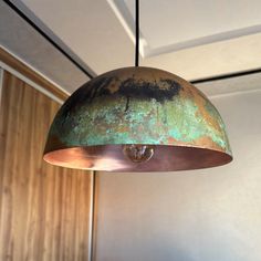 an old rusty light hanging from a ceiling