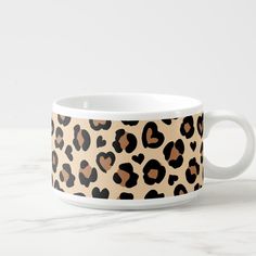 a leopard print coffee mug with hearts on it