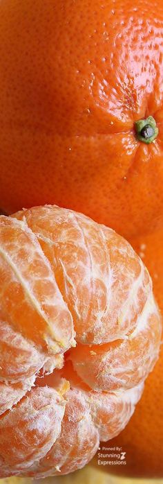 two oranges sitting next to each other on a table