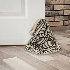 a white door with a black and white pattern on it next to a wooden floor