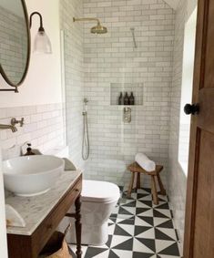 a bathroom with black and white tiles on the floor