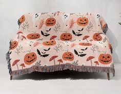 a couch covered in halloween pumpkins and bats