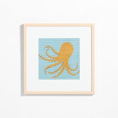 an octopus is on the wall in front of a white wall with blue and yellow stripes