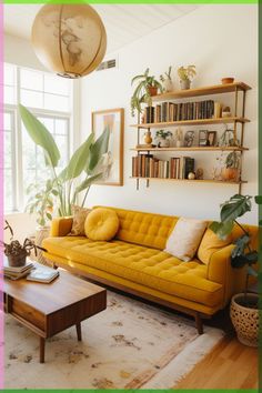 a living room with yellow couches and bookshelves on the wall above them