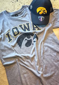 two hats are laying on top of each other next to a t - shirt that says iowa