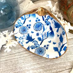 a blue and white plate sitting on top of a wooden table next to snowflakes