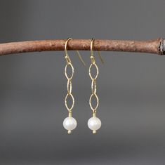 "Elegant white Akoya pearls are wire wrapped with 18k gold vermeil pins onto delicate 18k gold vermeil links. These dangle from 18k gold vermeil balled earwires. Wear these earrings everyday and into the evening. Each pair of pearls will very slightly. These are wonderful gifts for bridesmaids! Gold vermeil links: 4x8mm White pearls: 6mm Total length of earrings: 1 5/8\" All gold is 18k gold vermeil (gold plating over sterling silver). These earrings are also available in silver... www.etsy.com/ Elegant Wire-wrapped Yellow Gold Pearl Earrings, Elegant Yellow Gold Wire Wrapped Pearl Earrings, Yellow Gold Wire Wrapped Pearl Earrings Gift, Wire Wrapped Yellow Gold Pearl Earrings Gift, Pearl Wire Wrapped Earrings For Anniversary, Elegant Wire Wrapped Drop Linear Earrings, Pearl And Gold Earrings, Keshi Pearl Earrings, Handmade Pearl Jewelry