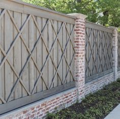 a brick fence with wooden slats on it