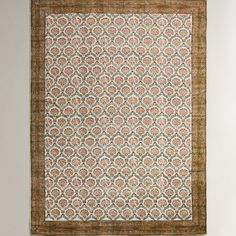 an area rug hanging on the wall with a brown and tan border around it,