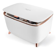 an image of a white and copper icebox with chocolates in the bottom compartment