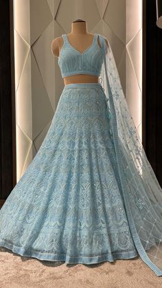 a light blue lehenga with matching crop top and dupatta