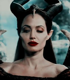 a woman with horns on her head and red lipstick