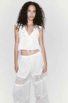 Lace-inset Crêpe Pants - Regular waist - Long - Cream - Ladies | H&M US Cropped Summer Bottoms For Daywear, Casual Ruffle Bottoms In Rayon, Casual Rayon Bottoms With Ruffles, Chic Lace Trim Bottoms For Spring, Chic Lace Trim Pants For Spring, Chic Spring Bottoms With Lace Trim, Chic Spring Pants With Lace Trim, Chic Pants With Lace Trim For Spring, Feminine Bottoms With Ruffle Hem For Vacation